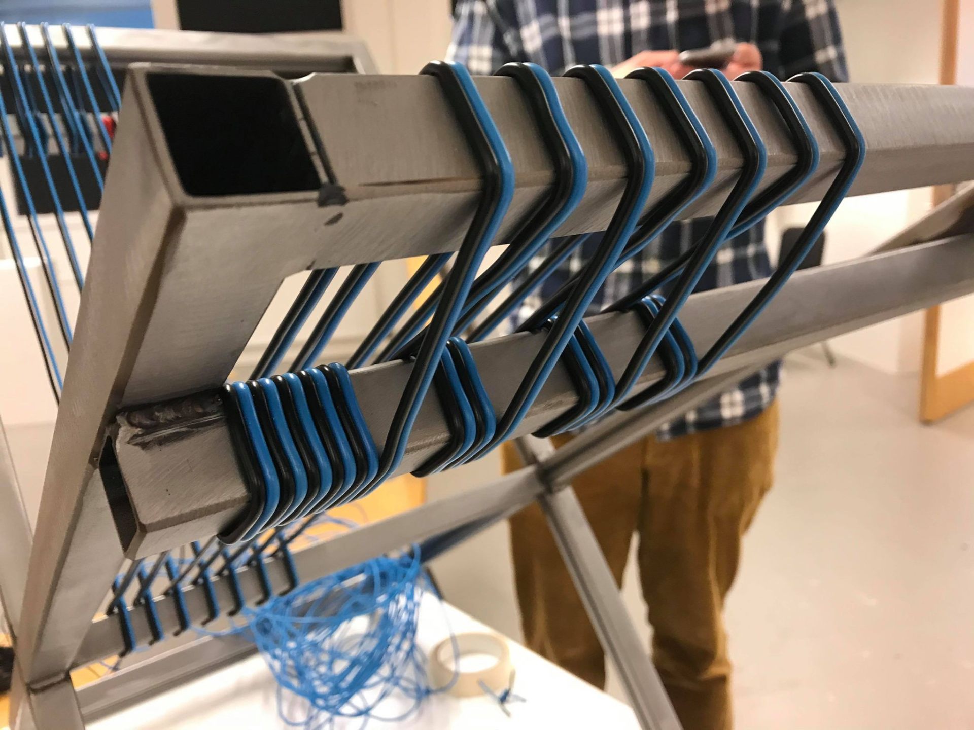 Stolen chair — horizontal weaving lines on steel frame in progress